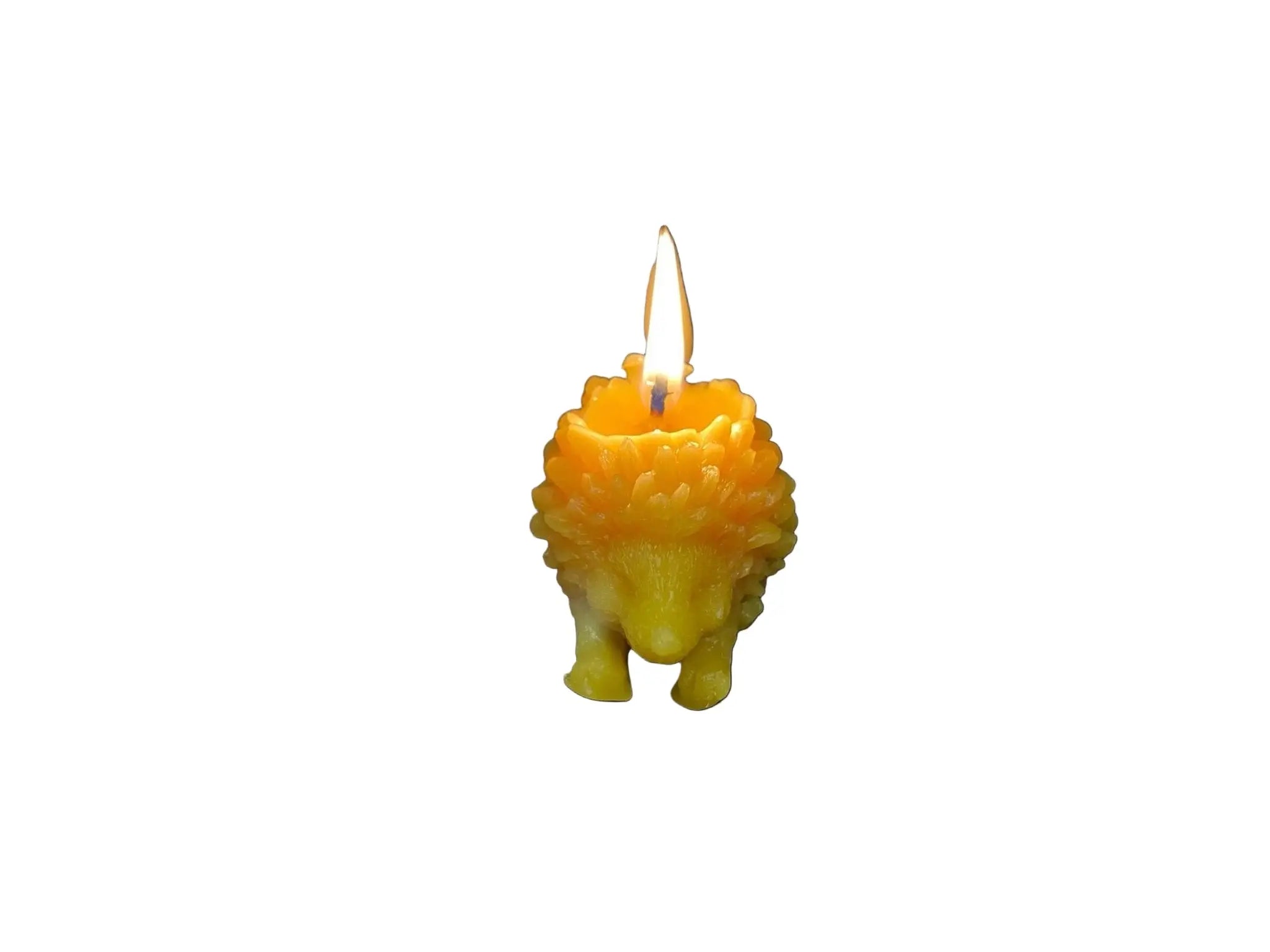 Lit natural beeswax candle shaped like a detailed hedgehog on white background