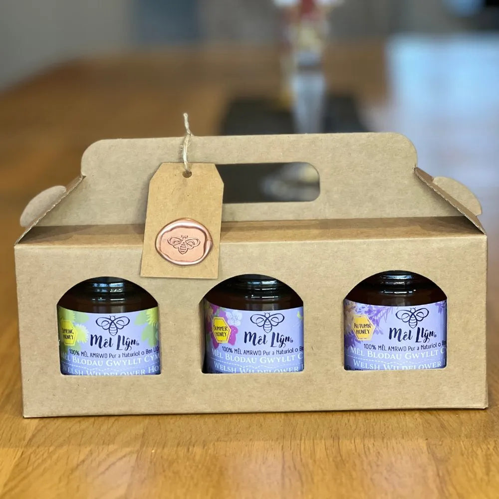 3 jars of seasonal welsh honey in a gift box and a wax seal tag