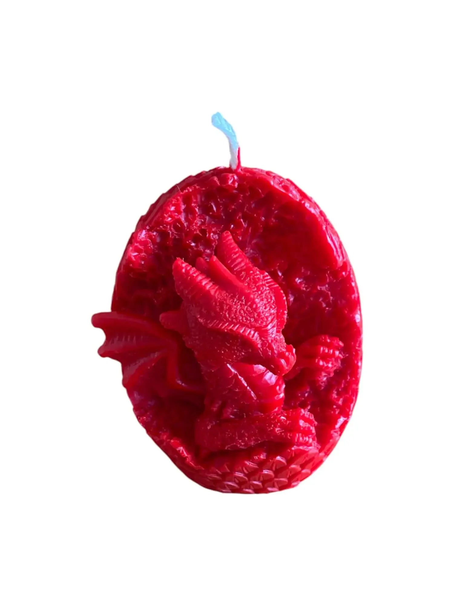 Red candle shaped like a dragon hatching from an egg with detailed scales and wings