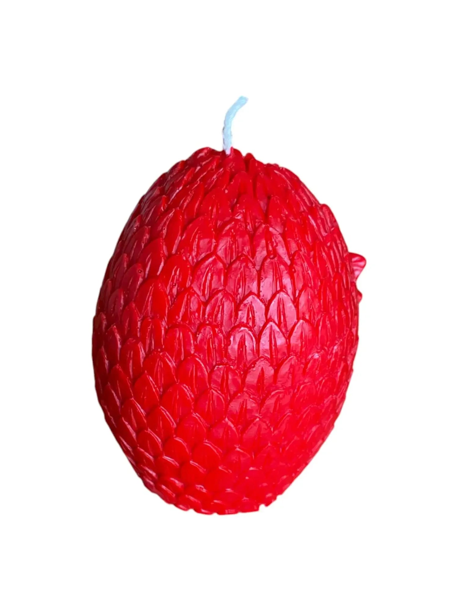 Red Welsh dragon egg candle with detailed scale texture and white wick