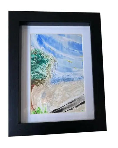 Framed encaustic artwork featuring a vibrant green tree against a blue and beige abstract background
