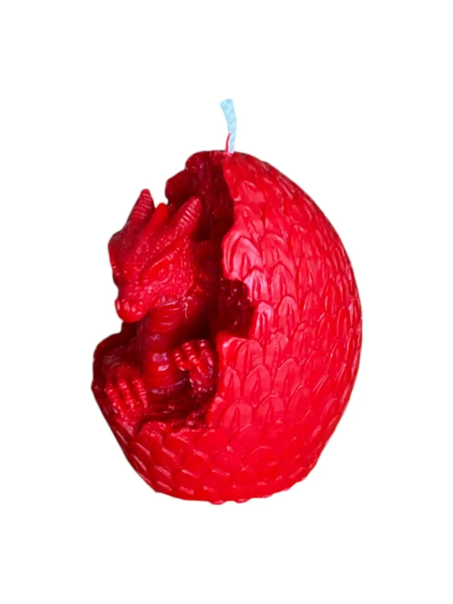 Red Welsh dragon candle shaped like a dragon hatching from a textured egg with scales
