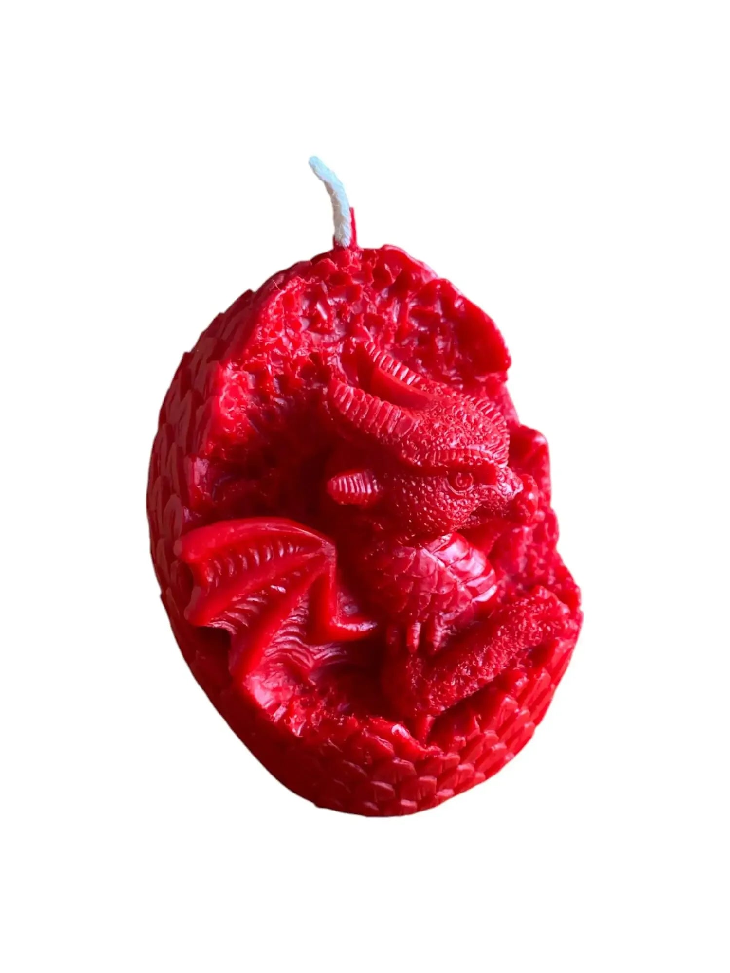 Red candle shaped like a dragon hatching from a textured egg with detailed wings and scales